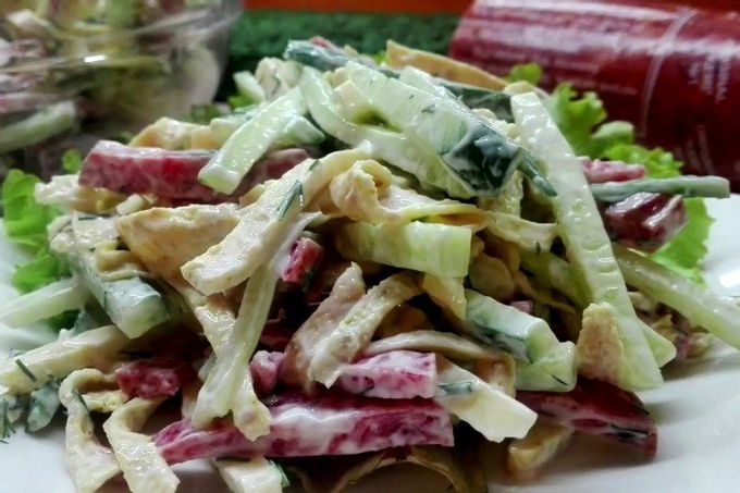Salad with egg pancakes, sausage and cucumbers