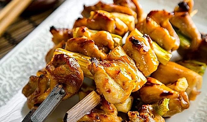 Ein Keramikteller mit Yakitori.
