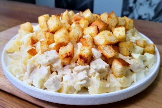 Festive salad with smoked chicken, cheese, pineapple and croutons