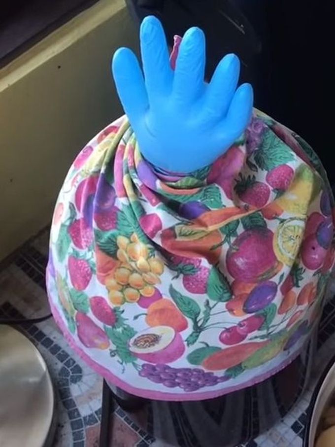 a bottle of wine with a glove